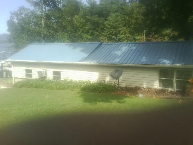 Blue metal roof running the length of a single story home in Whitfield